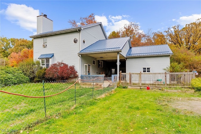 rear view of property featuring a yard