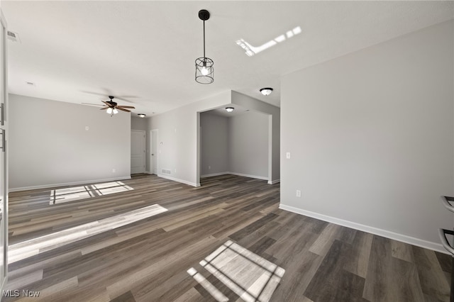 unfurnished living room with ceiling fan and dark hardwood / wood-style flooring