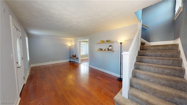 interior space with hardwood / wood-style flooring and a textured ceiling