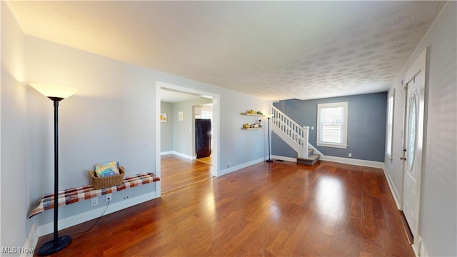 interior space featuring a textured ceiling and hardwood / wood-style flooring