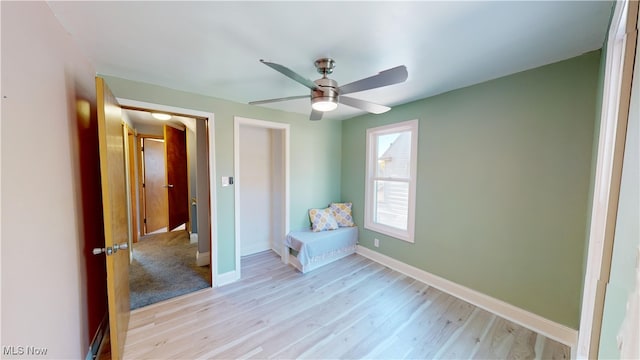 unfurnished bedroom with a closet, light wood-type flooring, and ceiling fan