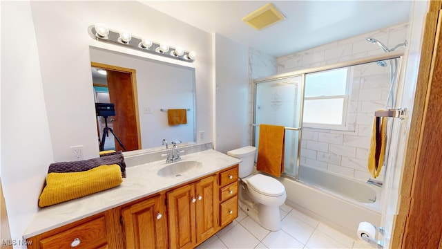 full bathroom featuring toilet, enclosed tub / shower combo, vanity, and tile patterned floors