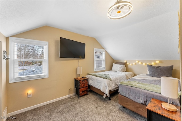 bedroom featuring a textured ceiling, carpet flooring, and vaulted ceiling