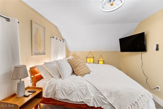 bedroom featuring lofted ceiling and carpet floors