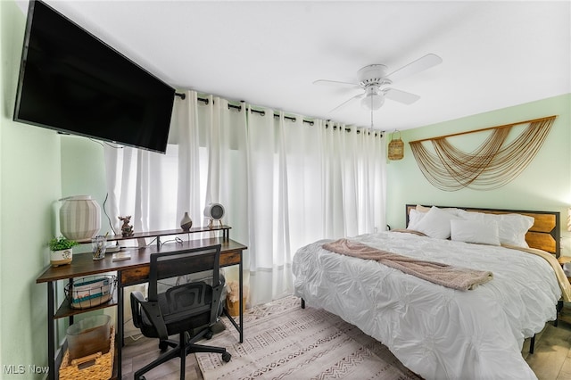 bedroom with hardwood / wood-style floors and ceiling fan