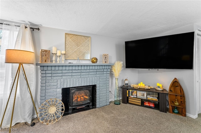 carpeted living room featuring a textured ceiling and a fireplace