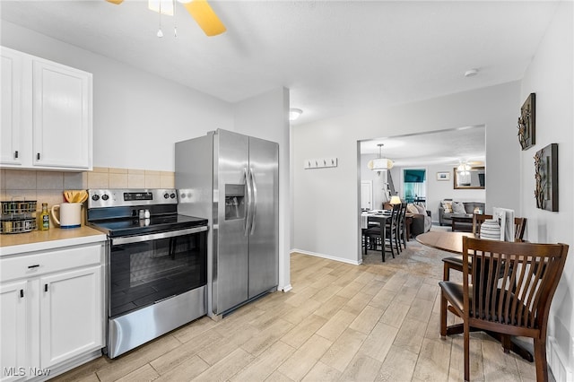 kitchen featuring appliances with stainless steel finishes, ceiling fan, white cabinets, and light hardwood / wood-style floors