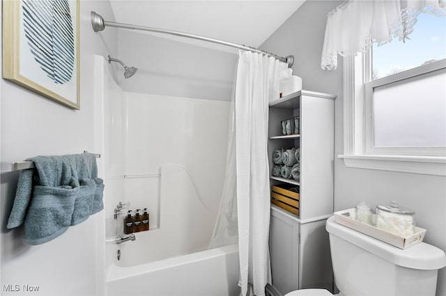 bathroom with shower / tub combo and toilet