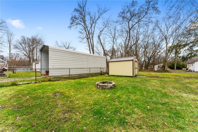 view of yard with a shed and a fire pit