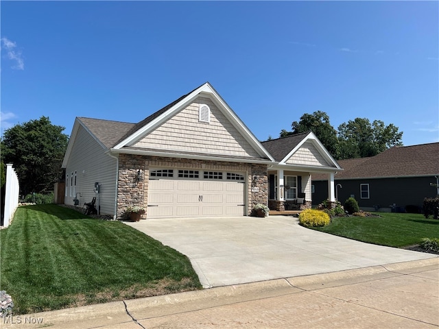 craftsman house with a front yard and a garage