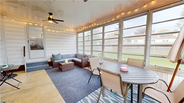 sunroom featuring ceiling fan