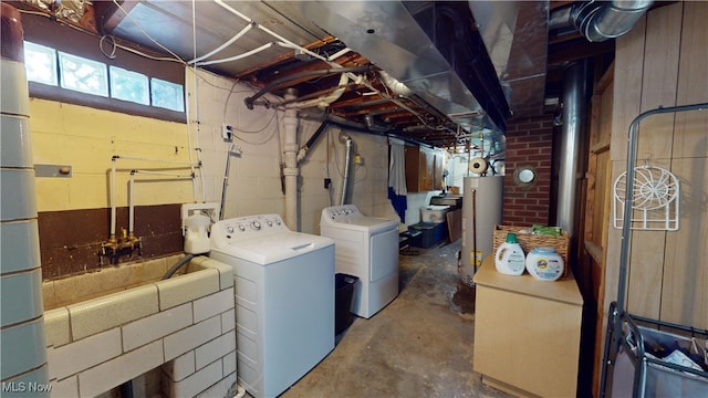 basement featuring water heater and washer and dryer