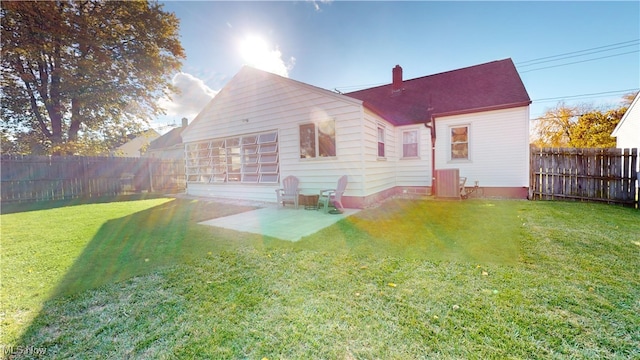 back of property featuring a yard and a patio