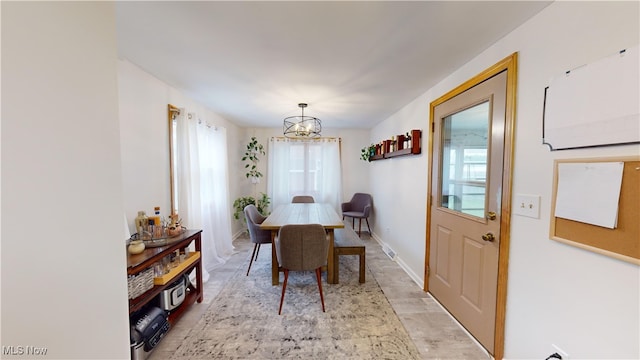 dining area with an inviting chandelier and plenty of natural light