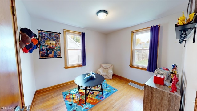 recreation room with a wealth of natural light and hardwood / wood-style flooring