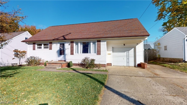 view of front of property with a front yard and a garage