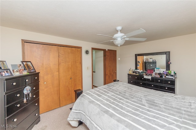 bedroom featuring light colored carpet and ceiling fan