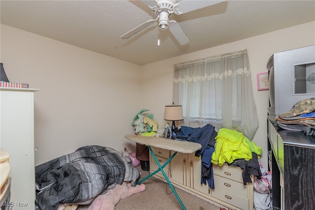 bedroom featuring carpet, a textured ceiling, and ceiling fan