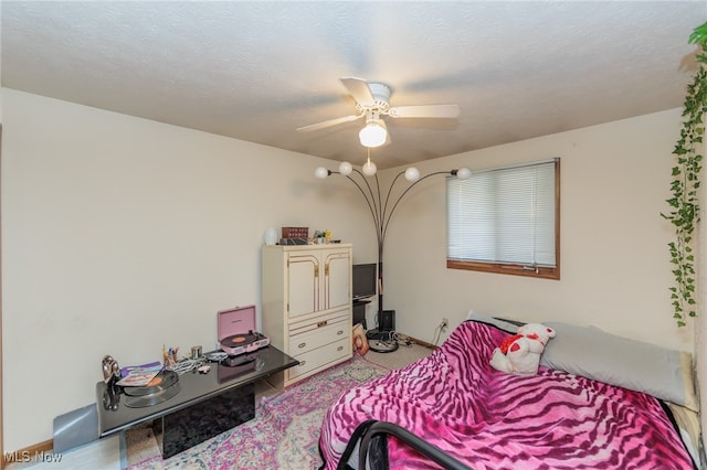 bedroom with a textured ceiling and ceiling fan