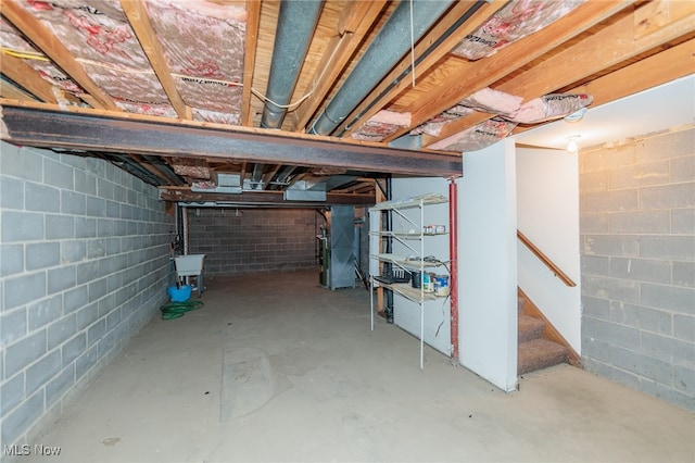 basement with heating unit and sink