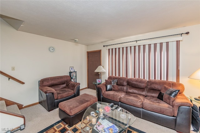 living room with carpet floors and a textured ceiling