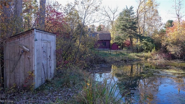 exterior space with a shed and a water view