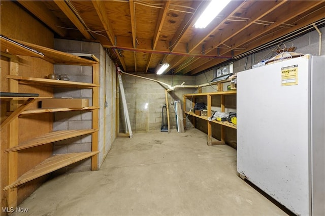 basement featuring white refrigerator