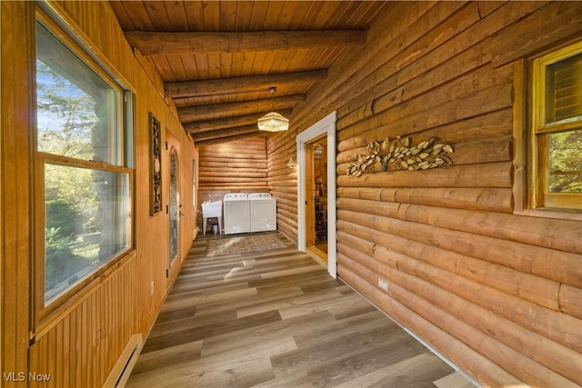 hall with vaulted ceiling with beams, washing machine and dryer, rustic walls, wood-type flooring, and wood ceiling