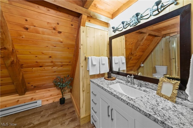 bathroom with wooden ceiling, a baseboard radiator, vaulted ceiling with beams, wood walls, and hardwood / wood-style floors