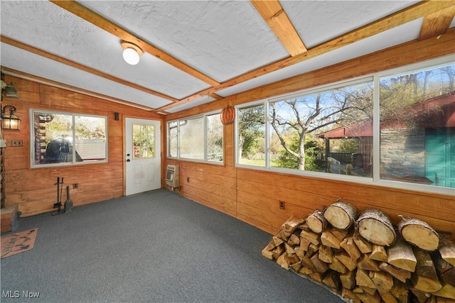 unfurnished sunroom featuring lofted ceiling with beams and heating unit