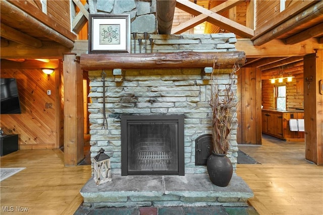 interior details featuring hardwood / wood-style floors, wood walls, and a fireplace