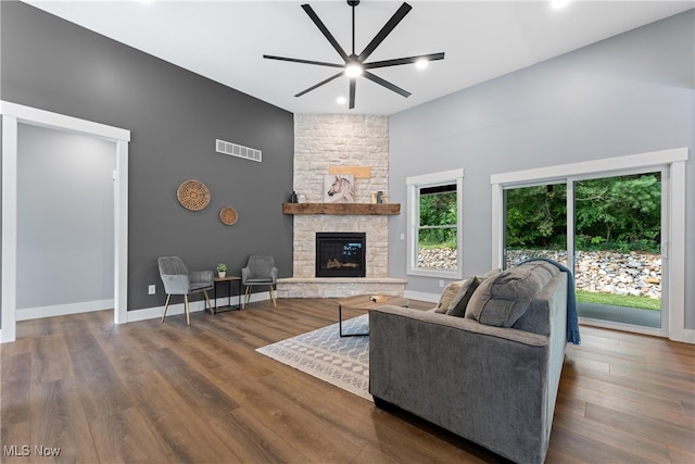 living room featuring a fireplace, dark hardwood / wood-style floors, and ceiling fan