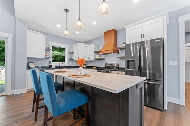 kitchen featuring a center island, appliances with stainless steel finishes, and white cabinets