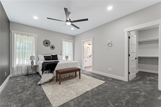 carpeted bedroom with a spacious closet, connected bathroom, a closet, and ceiling fan