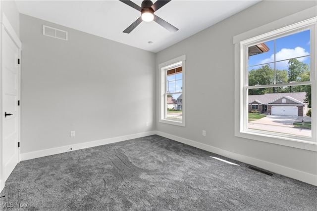 carpeted spare room with ceiling fan