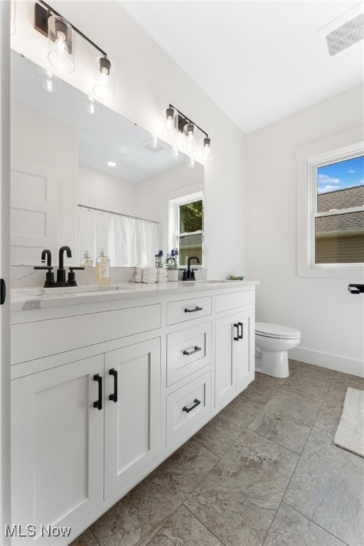 bathroom with vanity and toilet