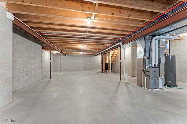 basement featuring gas water heater and heating unit