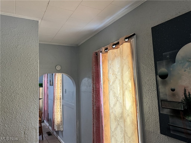 interior details with crown molding and tile patterned flooring