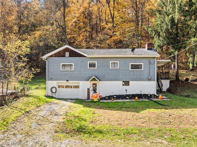 view of front of house with a front lawn and a garage