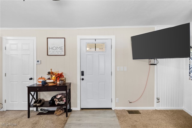 entrance foyer with crown molding and light wood-type flooring