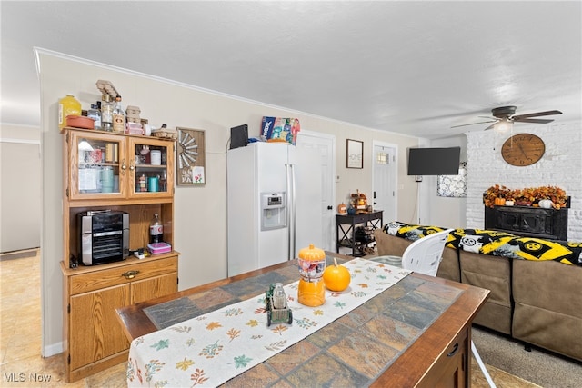 dining space featuring crown molding and ceiling fan