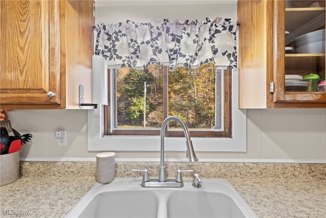 room details featuring sink and light stone countertops