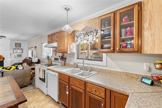 kitchen with ornamental molding, sink, hanging light fixtures, and white appliances