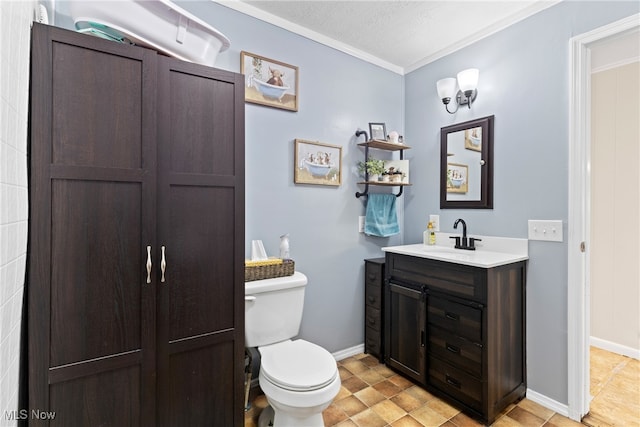 bathroom with vanity, toilet, ornamental molding, and a textured ceiling