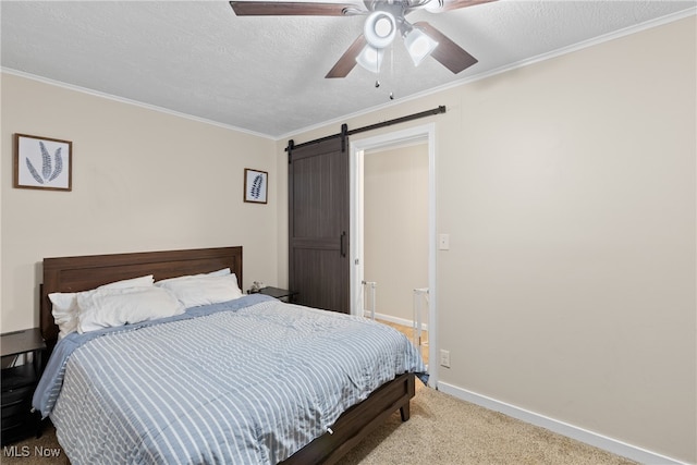 bedroom with light colored carpet, ceiling fan, a textured ceiling, and a barn door