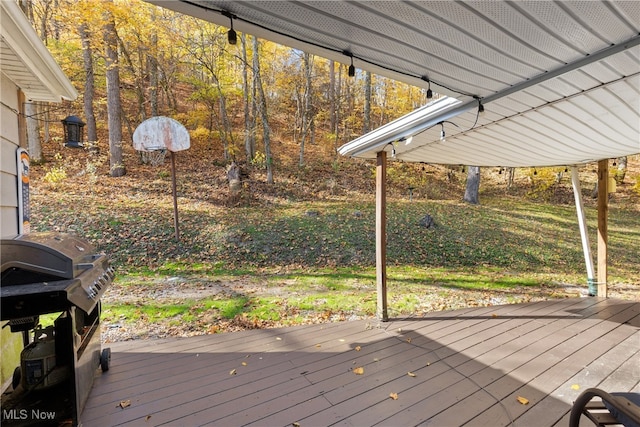 wooden terrace with a grill