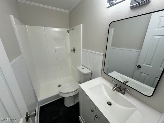 bathroom featuring vanity, toilet, a shower, and ornamental molding