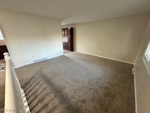 carpeted empty room with a healthy amount of sunlight