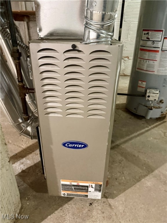 utility room with heating unit and gas water heater