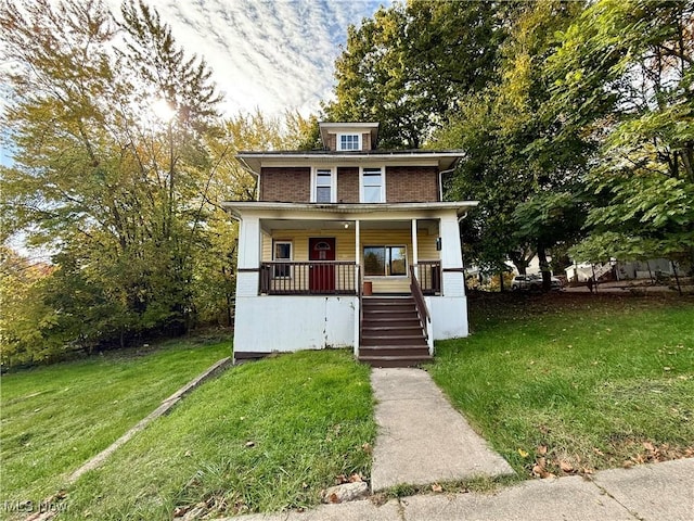 traditional style home with a porch, stairway, and a front yard